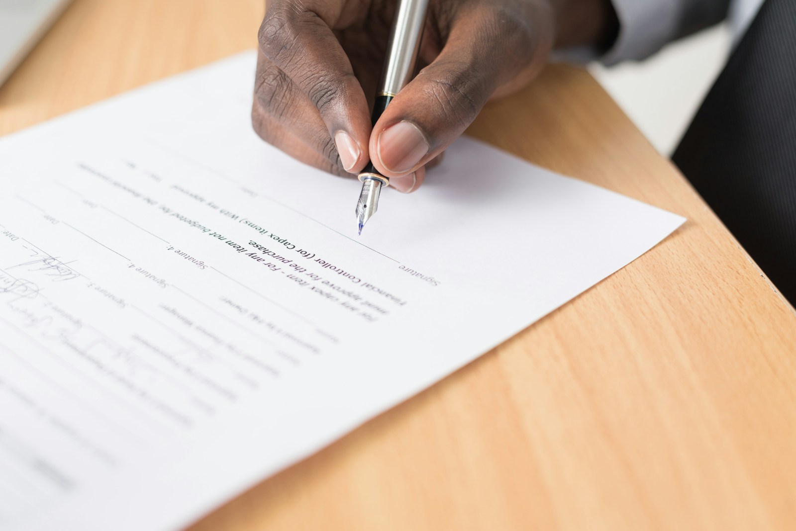 Investor signing an agreement at a desk